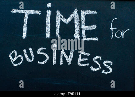 Time for business message handwritten with white chalk on blackboard, successful business concept Stock Photo