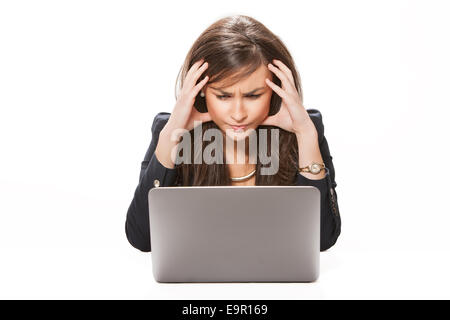 Young desperate business woman working on laptop Stock Photo