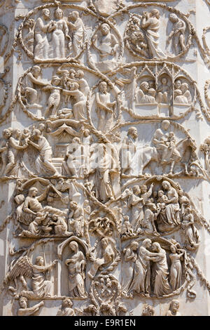 Orvieto, Umbria, Italy. Intricately carved bas-relief depicting scenes from the New Testament on façade of the cathedral. Stock Photo