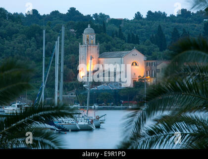 Portovenere, Liguria, Italy. View to the illuminated Santuario di Nostra Signora delle Grazie, dusk. Stock Photo