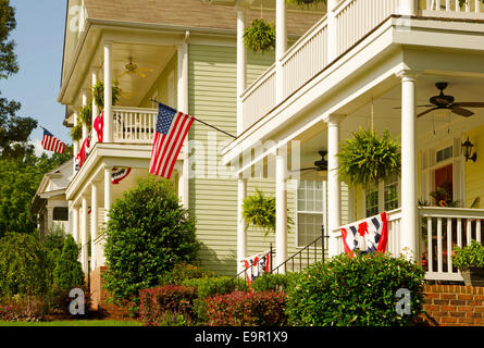 American Flags and buntings hang from the front porches of these upscale, Victorian homes in celebration of the upcoming holiday Stock Photo