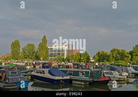 Boats moored at Becket's Park Marina, Northampton, the headquarters of Avon Cosmetics in the background. Stock Photo