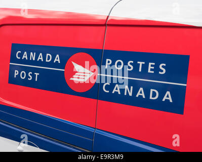 Bilingual Canada Post/Postes Canada logo on a postal delivery vehicle Stock Photo