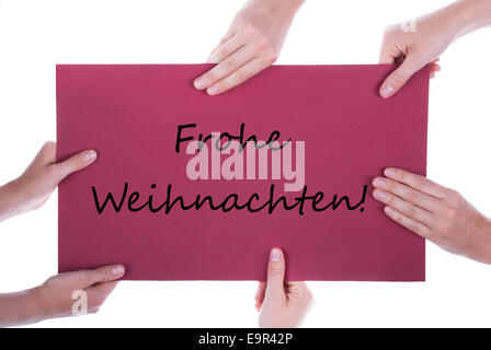 Many Hands Holding a Red Sign togehter with the German Words Frohe Weihnachten which means Merry Christmas Stock Photo