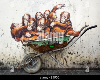 Orangutans in a Wheelbarrow street art mural by Lithuanian artist Ernest Zacharevic in Kuching, Sarawak, East Malaysia. Stock Photo