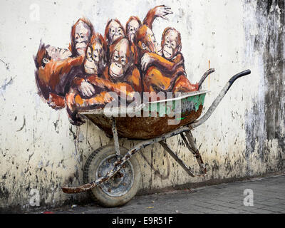 Orangutans in a Wheelbarrow street art mural by Lithuanian artist Ernest Zacharevic in Kuching, Sarawak, East Malaysia. Stock Photo