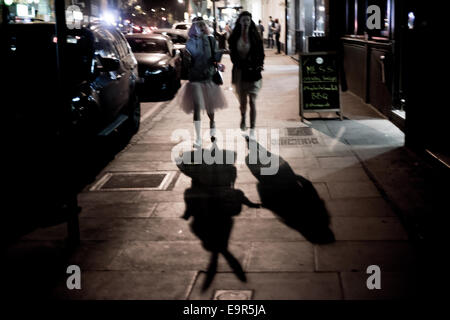 London, UK - 31 October 2014: The shadow of two women in fancy dress during the Halloween celebrations in Shoreditch Credit:  Piero Cruciatti/Alamy Live News Stock Photo