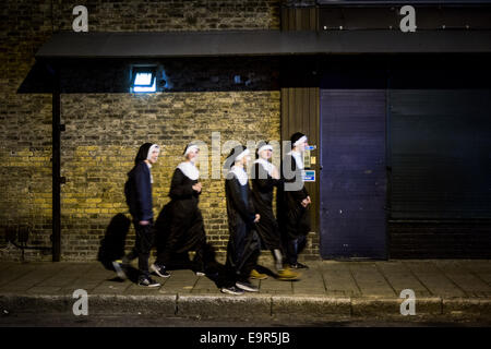 London, UK - 31 October 2014: a group of young men dressed as nuns during the Halloween celebrations in Shoreditch Credit:  Piero Cruciatti/Alamy Live News Stock Photo