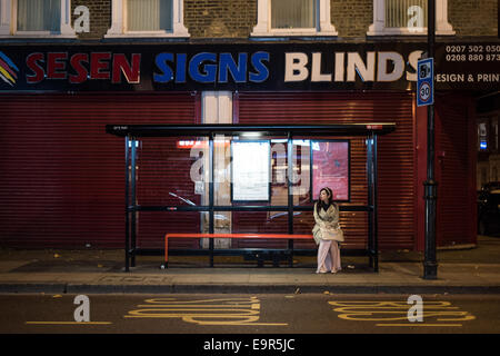 London, UK - 31 October 2014: a young woman in fancy dress waits for her bus during the Halloween celebrations in Dalston Credit:  Piero Cruciatti/Alamy Live News Stock Photo