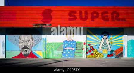 Colorful murals on exterior wall of old grocery store Stock Photo