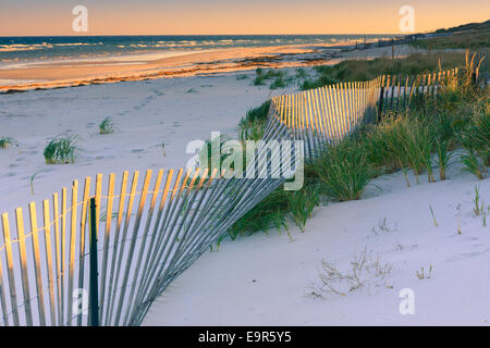 Sand Dune Fences at sunrise over the Atlantic ocean on Cape Cod, Massachusetts Stock Photo