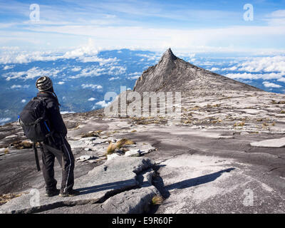 Climber at the top of Mount Kinabalu in Sabah, Malaysia. Stock Photo