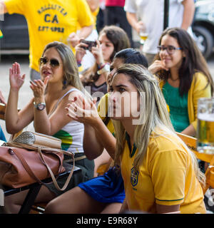 Group of Brazilian girls watching World Cup football match on TV at a bar in Salvador, Bahia, Brazil. Stock Photo