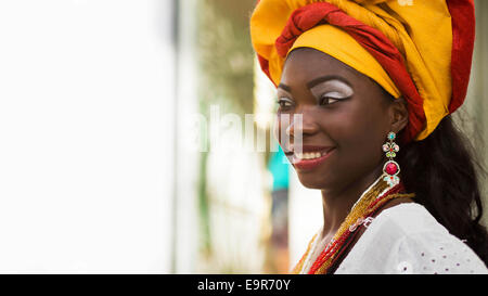 Baiana, Brazilian woman of African descent, smiling, wearing traditional clothes in Pelourinho, Salvador, Bahia, Brazil. Stock Photo