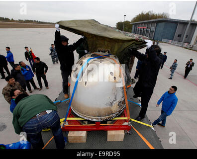 Beijing, China. 1st Nov, 2014. Staff members transfer the return capsule of China's unmanned lunar orbiter in Beijing, capital of China, Nov. 1, 2014. The return capsule of China's test lunar orbiter, nicknamed 'Xiaofei', arrived in Beijing on Saturday after it landed successfully in north China's Inner Mongolia Autonomous Region earlier on the same day. Credit:  Shen Bohan/Xinhua/Alamy Live News Stock Photo