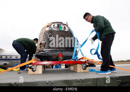 Beijing, China. 1st Nov, 2014. Staff members tether the return capsule of China's unmanned lunar orbiter onto a truck in Beijing, capital of China, Nov. 1, 2014. The return capsule of China's test lunar orbiter, nicknamed 'Xiaofei', arrived in Beijing on Saturday after it landed successfully in north China's Inner Mongolia Autonomous Region earlier on the same day. Credit:  Shen Bohan/Xinhua/Alamy Live News Stock Photo
