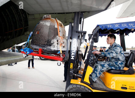 Beijing, China. 1st Nov, 2014. Staff members unload the return capsule of China's unmanned lunar orbiter from a carrier aircraft in Beijing, capital of China, Nov. 1, 2014. The return capsule of China's test lunar orbiter, nicknamed 'Xiaofei', arrived in Beijing on Saturday after it landed successfully in north China's Inner Mongolia Autonomous Region earlier on the same day. Credit:  Shen Bohan/Xinhua/Alamy Live News Stock Photo