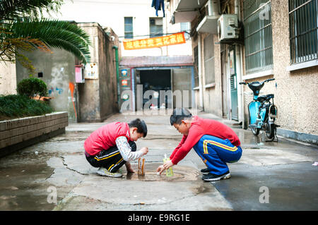 Two boys playing in a residential alley in Shanghai's old town Stock Photo