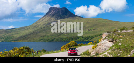 Motorist on touring holiday by Stac Pollaidh, Stack Polly mountain in Inverpolly National Nature Reserve in Coigach area of Nort Stock Photo