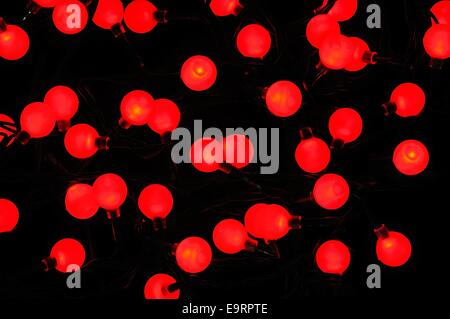 Modern Christmas LED berry lights against a black background. Stock Photo