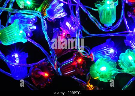 Modern Christmas LED Canterbury bells lights against a black background. Stock Photo