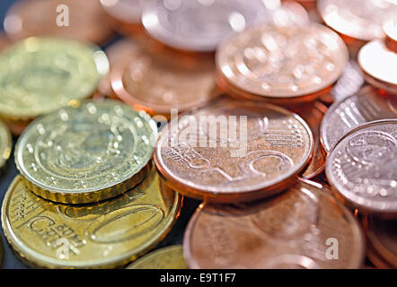 Closeup image of used euro coins under sun beams Stock Photo