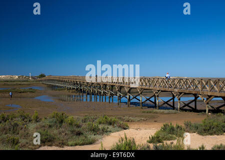 The longest wooden bridge in Europe crosses to Praia do Gigi, in the Ria Formosa Nature Park, Quinta do Lago, Algarve, Portugal. Stock Photo