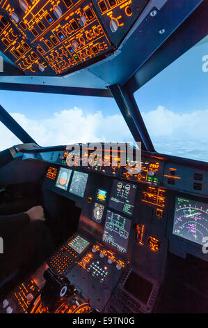 Cockpit of an Airbus A320 flight simulator that is used for training of professional airline pilots (during 'flight') Stock Photo