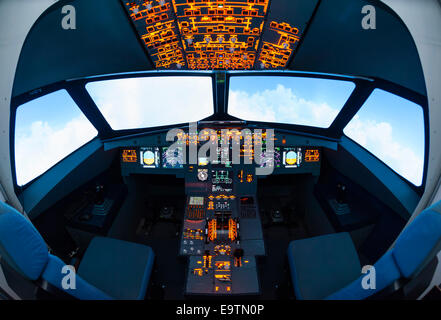 Cockpit of an Airbus A320 flight simulator that is used for training of professional airline pilots (fisheye lens distortion) Stock Photo