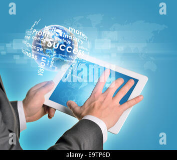 Man hands using tablet pc. Earth and business words near computer Stock Photo