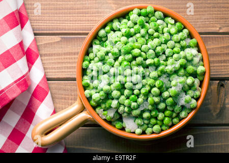 frozen peas on kitchen table Stock Photo