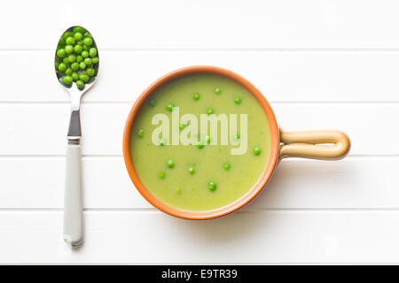 top view of pea soup and peas in spoon Stock Photo