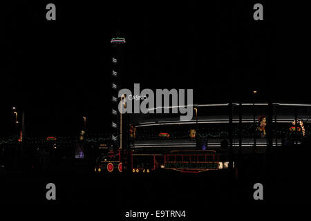 Night view illuminated Western Train Tram moving north tramway in front of neon Pleasure Beach Casino, Blackpool Illuminations Stock Photo