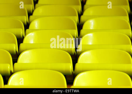 Empty yellow chairs in rows. Stock Photo