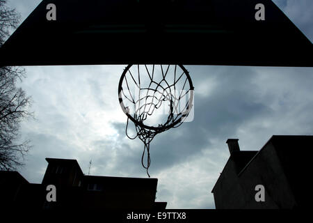A silhouette of a basketball hoop at playground, taken from below. Stock Photo