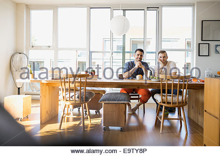 Portrait of confident homosexual couple at table