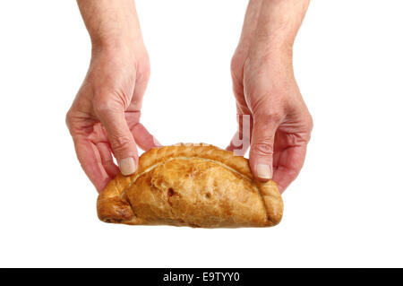 Pair of hands holding a Cornish pasty isolated against white Stock Photo