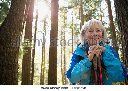 Portrait of smiling senior woman hiking in woods