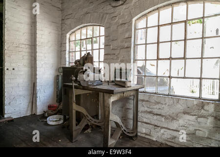 Engineering work shop with industrial  cast iron work bench and metal vice Stock Photo