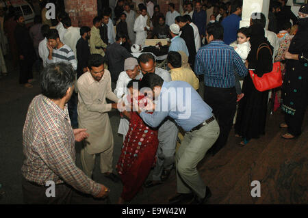 Lahore. 2nd Nov, 2014. People transfer an injured woman to a hospital in eastern Pakistan's Lahore on Nov. 2, 2014. Death toll rose to 54 and over 100 others were injured in the Sunday evening's suicide blast that took place near Wagah border crossing in Pakistan's eastern city of Lahore, hospital sources said. Credit:  Sajjad/Xinhua/Alamy Live News Stock Photo