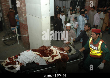 Lahore. 2nd Nov, 2014. People transfer an injured man to a hospital in eastern Pakistan's Lahore on Nov. 2, 2014. Death toll rose to 54 and over 100 others were injured in the Sunday evening's suicide blast that took place near Wagah border crossing in Pakistan's eastern city of Lahore, hospital sources said. Credit:  Sajjad/Xinhua/Alamy Live News Stock Photo