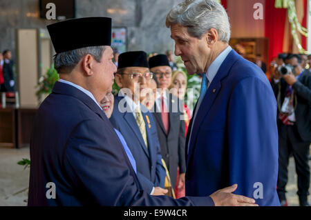 U.S. Secretary of State John Kerry chats with outgoing Indonesian President Susilo Bambang Yudhoyono as he arrives to represent Stock Photo