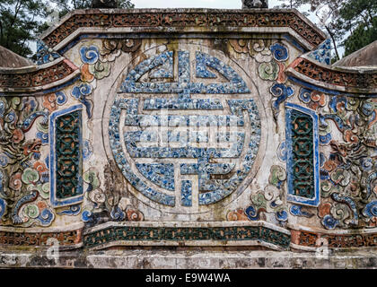 Vietnam Hué Emperor Tu Doc's mausoleum: mosaic sculpture of Chinese longevity symbol on wall. Stock Photo