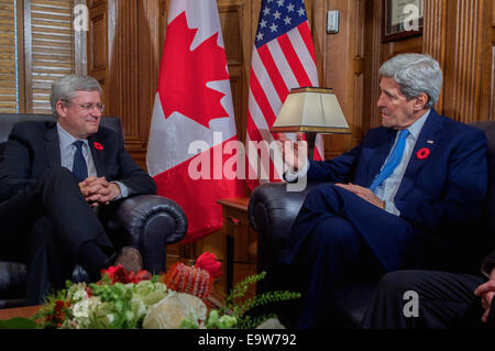 U.S. Secretary of State John Kerry addresses Canadian Prime Minister Stephen Harper after he welcomed him to his office on Parliament Hill in Ottawa, Canada, on October 28, 2014, as the Secretary visited to pay condolences following last week's attacks an Stock Photo