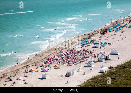 Aerial view of sunbathers, swimmers, surf and cabanas along South Beach, Miami Beach, Florida, USA. Stock Photo