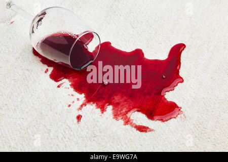 Red wine is spilled on a carpet. Glass fallen over Stock Photo