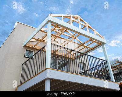 New residential construction home framing against a blue sky Stock Photo