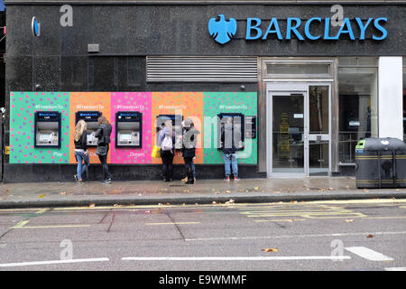 UK, England, London. Customers using ATM's at Barclays Bank, Leicester Square. Stock Photo