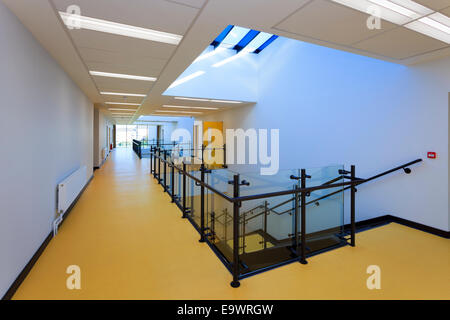 School corridor with stairs down and atrium roof lights Stock Photo