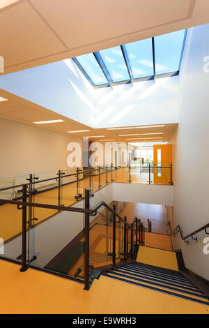 School corridor with stairs down and atriun roof lights Stock Photo